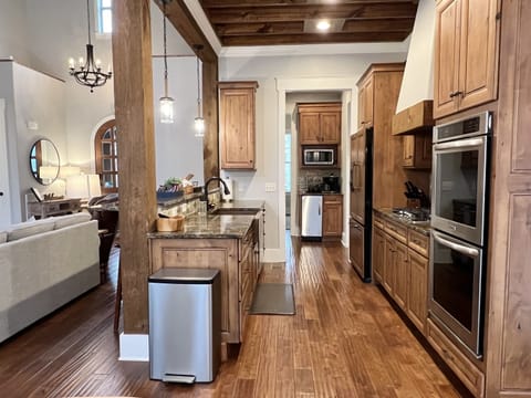 The kitchen includes a double oven, gas range, dishwasher, copper farmhouse sink, french door refrigerator with freezer drawer, ice machine, microwave, Keurig Duo, and a bluetooth speaker.