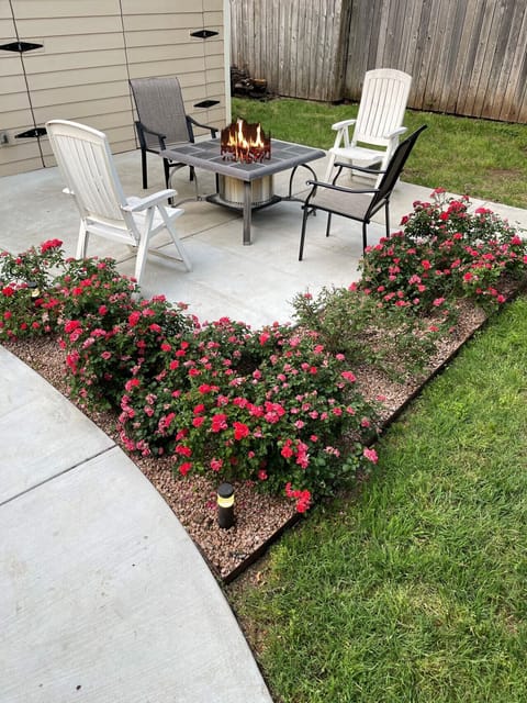 Backyard rose garden next to fire pit.