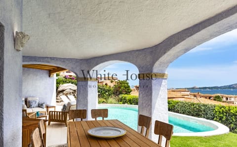 Outdoor dining with sea and pool view