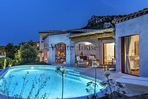 Swimming pool, sitting area and dining table outdoors
