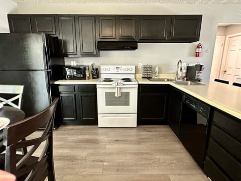 This fully equipped kitchen features modern appliances, ample counter space, and a cozy dining area perfect for enjoying meals with family or friends.