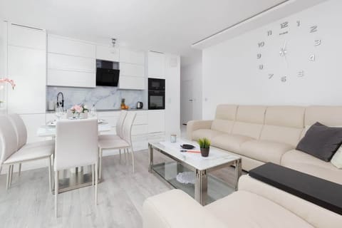 A spacious and bright living and dining area, blending comfort and functionality with chic furnishings.
