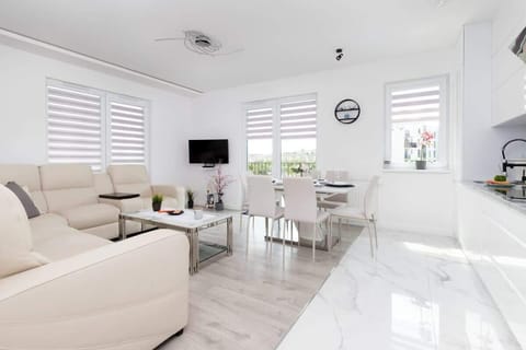 A wide-angle view of the open-plan living and dining area, highlighting the airy and modern design.
