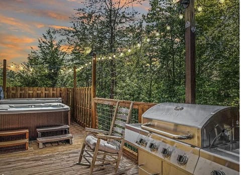 Relax in the private hot tub surrounded by peaceful wooded views