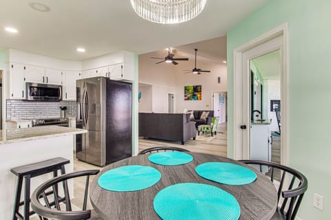 Dining room with crystal chandelier and wall of windows overlooking Pensacola Bay in Gulf Breeze Florida