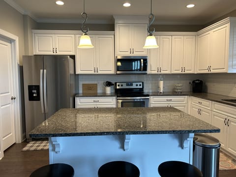 Inviting kitchen with large island to cook and gather
