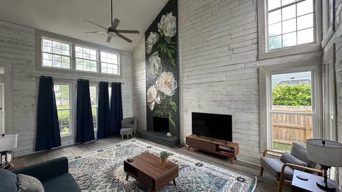 Living room with high ceiling and beautiful mural.  