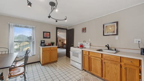 The upstairs kitchen leads into the queen bedroom.