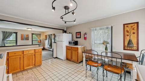 The upstairs kitchen leads into the living room.