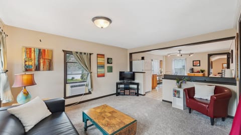 The upstairs living room leads into the kitchen, creating a wide-open space for your stay.