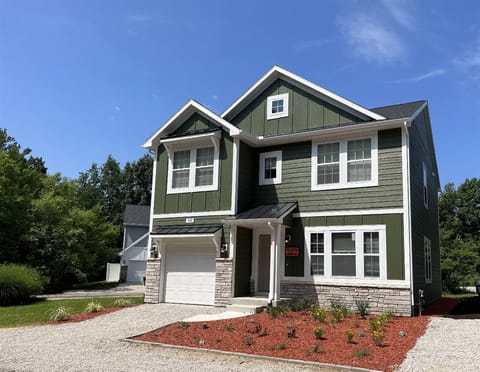 Welcome to Harbor Pointe, a spacious and modern getaway. This two-story home features crisp exterior finishes and a covered entryway.