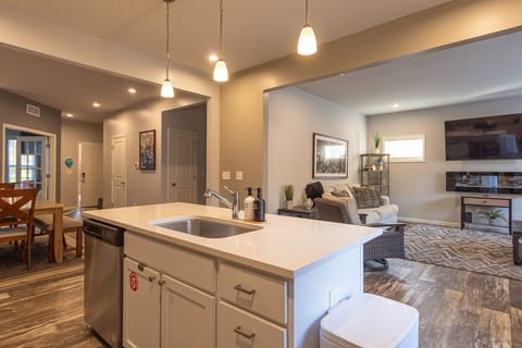 Open- concept main level at Harbor Pointe features a bright kitchen island overlooking the dining area and cozy living room