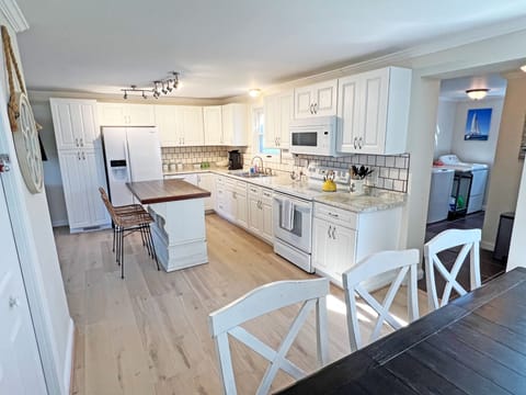 Large fridge, dishwasher, full oven/stove, microwave, and abundant cabinet space