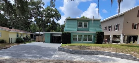 Front view of Mermaid Cove Cottage and paver driveway and parking area
