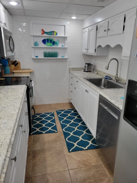 Galley style kitchen with ample room and well stocked 