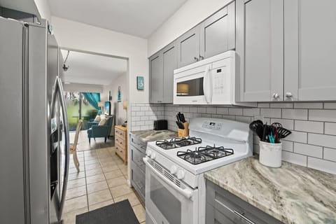Our upgraded kitchen is fully stocked for your stay, featuring a gas stove to meet all your culinary needs and open access to dining room and living room to enjoy!