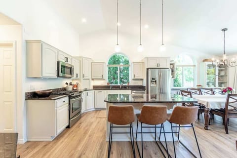 Fully stocked kitchen offering large island, granite counter tops, SS appliances, gas range