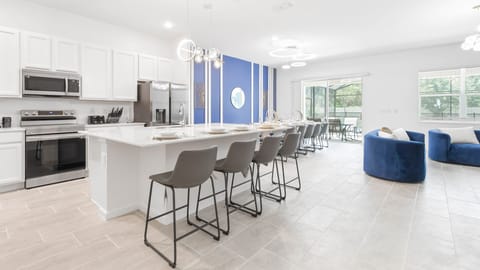 Spacious modern kitchen with a large island, sleek décor, and open-concept design.