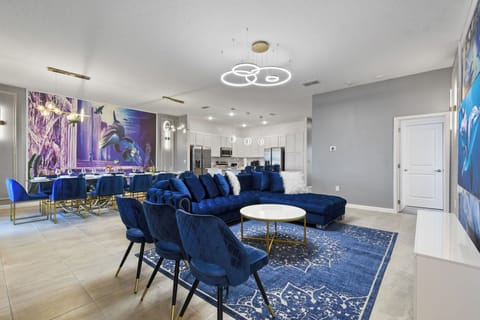 Spacious ocean-inspired living and dining area with luxe seating and bold murals