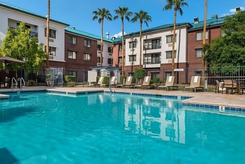 Dive into a sparkling pool surrounded by sunny loungers.