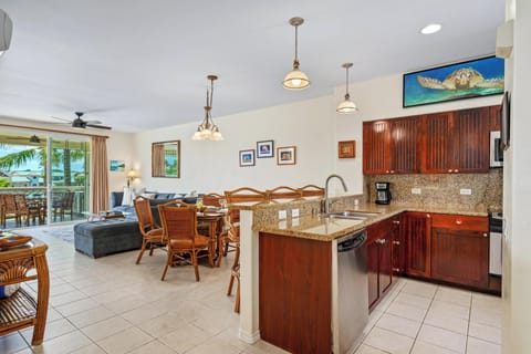 Spacious open layout connects the granite kitchen to the cozy living room and dining area.
