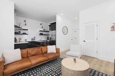 Our cozy living room is a great space to relax, with a comfortable leather couch, lots of natural light, and a Smart TV with all the streaming apps.