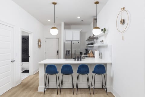 Seating for 4 at the kitchen counter off of the living room. Our kitchen is fully stocked with pots, pans, a Keurig, and premium appliances.