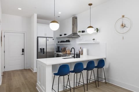 Seating for 4 at the kitchen counter off of the living room. Our kitchen is fully stocked with pots, pans, a Keurig, and premium appliances.