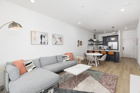 Our cozy living room is a great place to kick back - comfortable sectional sofa with a Smart TV + all the streaming apps and a balcony providing fresh air & natural light. Designed with your comfort & ease in mind.