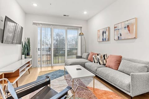 Our cozy living room is a great place to kick back - comfortable sectional sofa with a Smart TV + all the streaming apps and a balcony providing fresh air & natural light. Designed with your comfort & ease in mind.