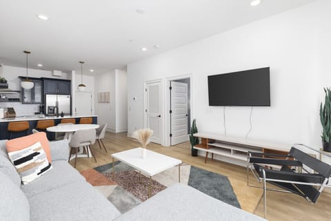 Our cozy living room is a great place to kick back - comfortable sectional sofa with a Smart TV + all the streaming apps and a balcony providing fresh air & natural light. Designed with your comfort & ease in mind.