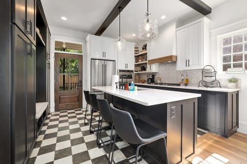 Our main kitchen features seating for four at the spacious island with white quartz countertops.