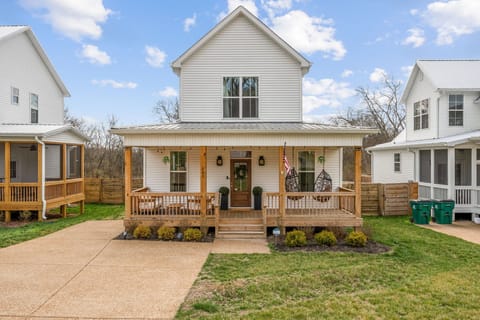 Charming farmhouse exterior with a welcoming front porch and cozy style.