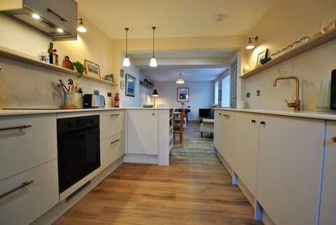 A fully fitted kitchen which leads to a dining area