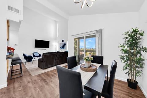 Bright dining area with seating for four, opening into the spacious living room.