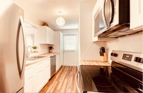 Full custom kitchen. Stainless and butcher block finishes.
