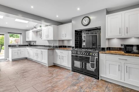 Here's our impeccably designed minimalist kitchen in this property! This thoughtfully curated space combines sleek aesthetics with functionality, creating a modern and fully furnished culinary haven. Step into this culinary sanctuary and prepare to be inspired.  A sleek refrigerator, a state-of-the-art oven and stove, a built-in microwave, and a dishwasher are all seamlessly in...