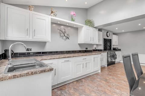 Kitchen cabinets and drawers feature minimalist design elements,  contributing to the streamlined aesthetic. They are skillfully crafted with high-quality materials, offering plenty of storage space for all cooking utensils, pots, pans, and pantry essentials.