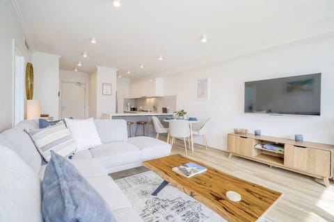 Smart TV in a bright, open-plan living and dining area