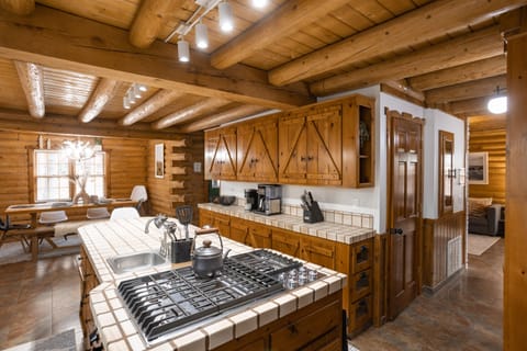 5-burner gas stove, prep sink, knotty pine cabinetry, upgraded lighting, island