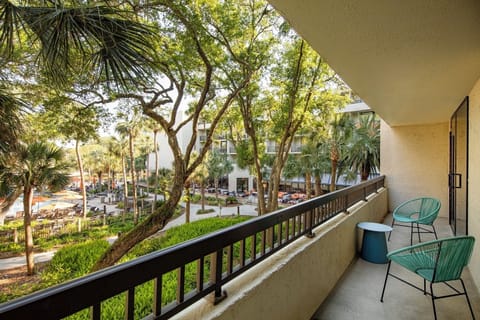Sip morning coffee on the balcony overlooking lush gardens.