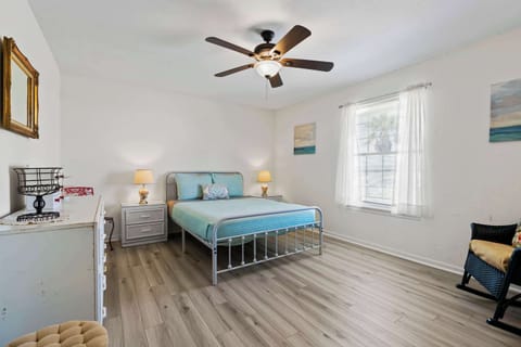 Queen bed, rocking chair, and ceiling fan.