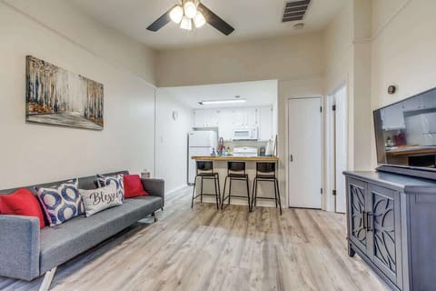 Bright and welcoming living room with stylish décor, comfortable seating, and a fully equipped kitchen for a convenient stay.