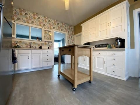 Bright and cheery kitchen loaded with storage and cookware.