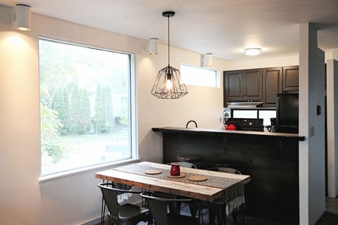 Dining table in area behind kitchen