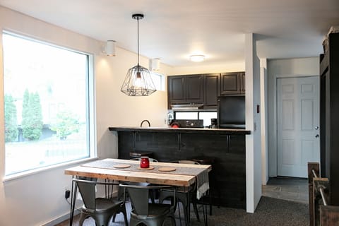 Dining table in area behind kitchen