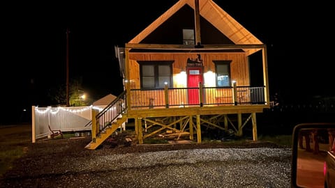 Cozy cabin with firepit and full porch with plenty of seating to relax 