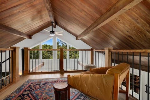 Up here, you can also enjoy a small seating area overlooking the living room.