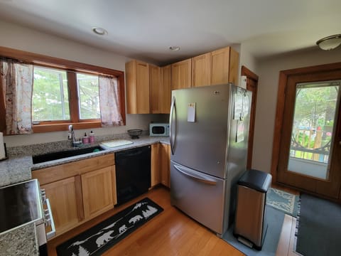Electric flattop oven, large refrigerator and dishwasher.