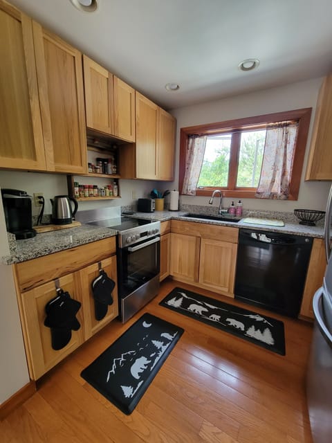 Thoughtfully stocked kitchen with spices,  new knives and cooking utencils.
